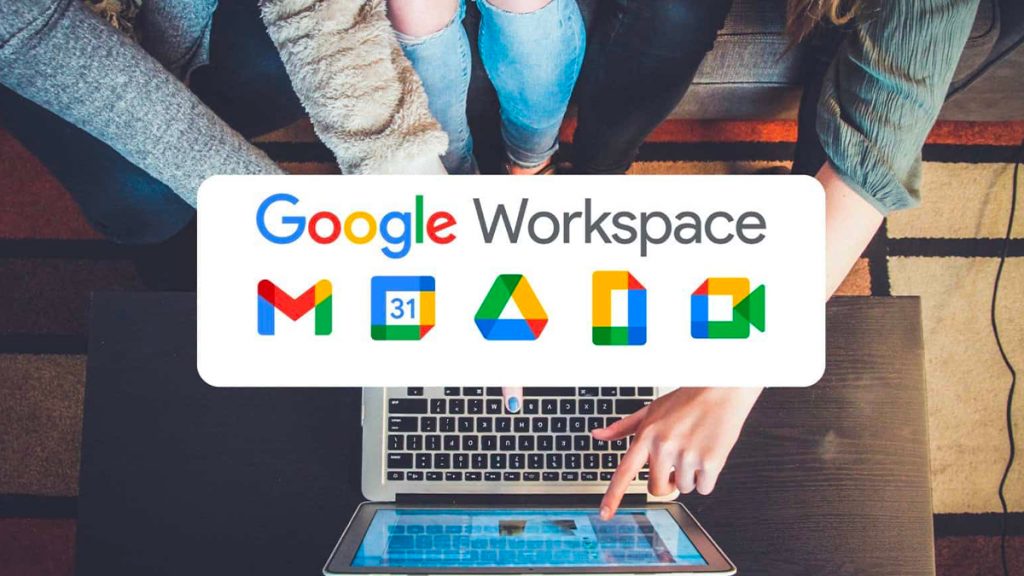 Image of Google Workspace with it's icons on the bottom and people touching an Apple MacBook