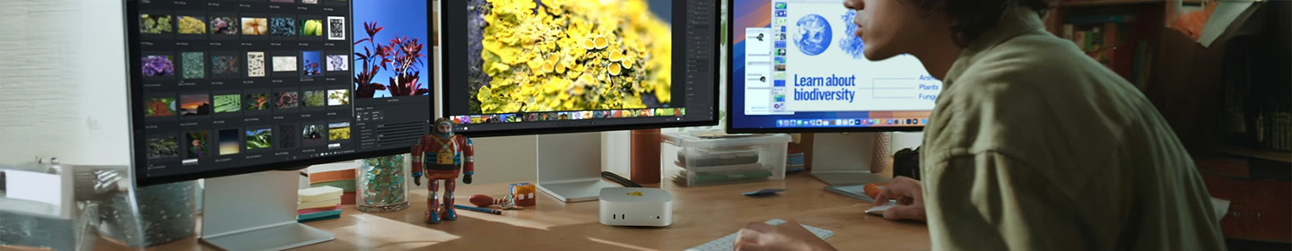 Man using Mac mini with M4 chip and iMac screens