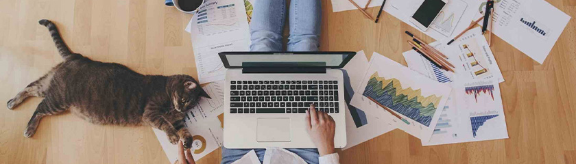 aerial shot, man sat on laptop working from home